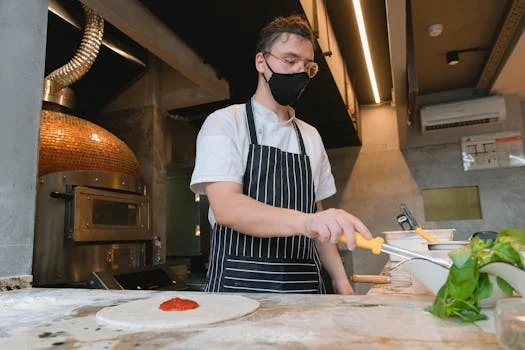 pizza chef tossing dough in air